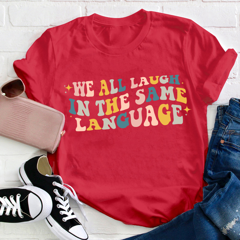 We All Laugh in the Same Language Teacher T-Shirt