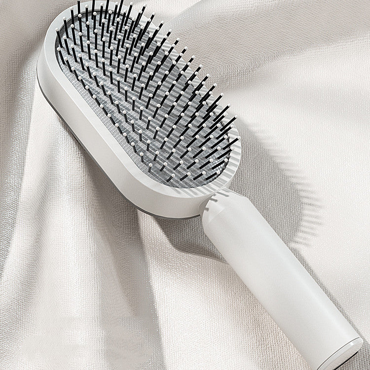 Self-cleaning hairbrush for women. One-button cleaning airbag to prevent hair loss