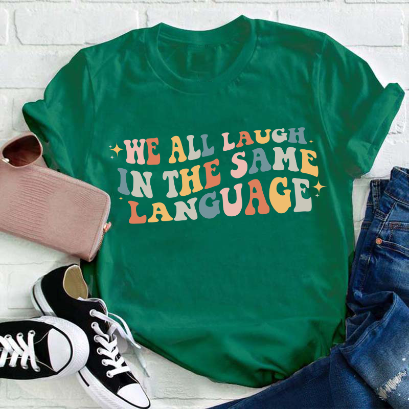 We All Laugh in the Same Language Teacher T-Shirt